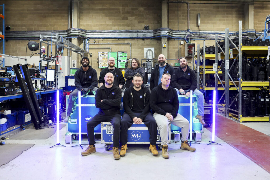 Warehouse team surrounded by a variety of hires lighting