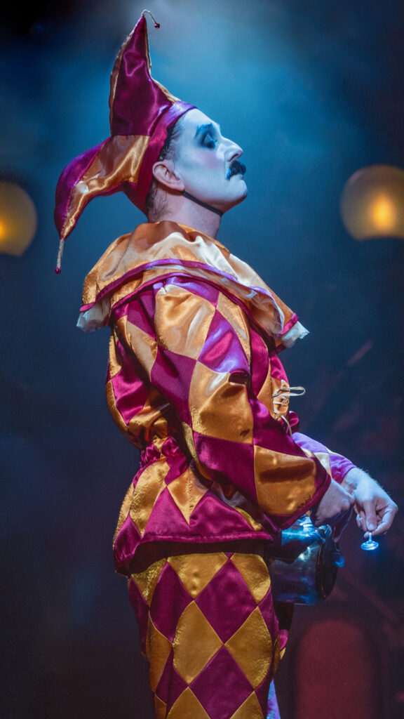 The Lost Estate - Chat Noir: performer dressed as a jester for an immersive 1890s Parisian cabaret experience